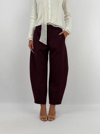 Pantalone Balloon Bordeaux Lumina - Pantalone modello balloon bordeaux con passanti in vita per cintura, tasche laterali e chiusura con zip, bottone e gancetto. | Paloma Store