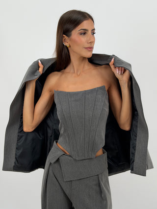 Top Corsetto Grigio Lumina - Top corsetto bustier grigio con struttura a stecche verticali frontali e posteriori. Senza spalline, con fondo inferiore sagomato e chiusura posteriore con zip. | Paloma Store