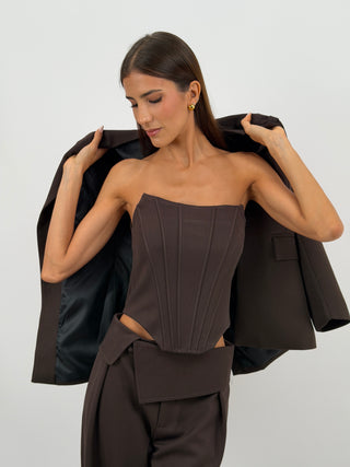 Top Corsetto Marrone Lumina - Top corsetto bustier marrone con struttura a stecche verticali frontali e posteriori. Senza spalline, con fondo inferiore sagomato e chiusura posteriore con zip. | Paloma Store