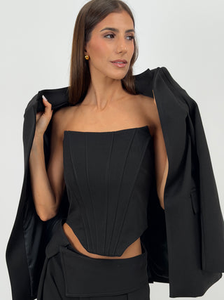 Top Corsetto Nero Lumina - Top corsetto bustier nero con struttura a stecche verticali frontali e posteriori. Senza spalline, con fondo inferiore sagomato e chiusura posteriore con zip. | Paloma Store